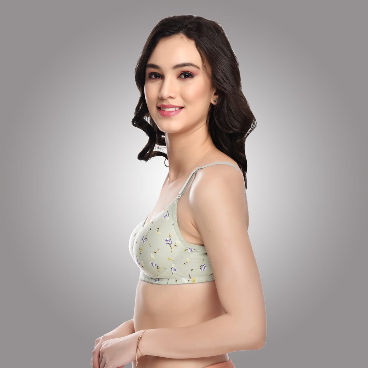 Angled side view of Liamoure green floral printed bra with adjustable straps and seamless padded design for stylish support.